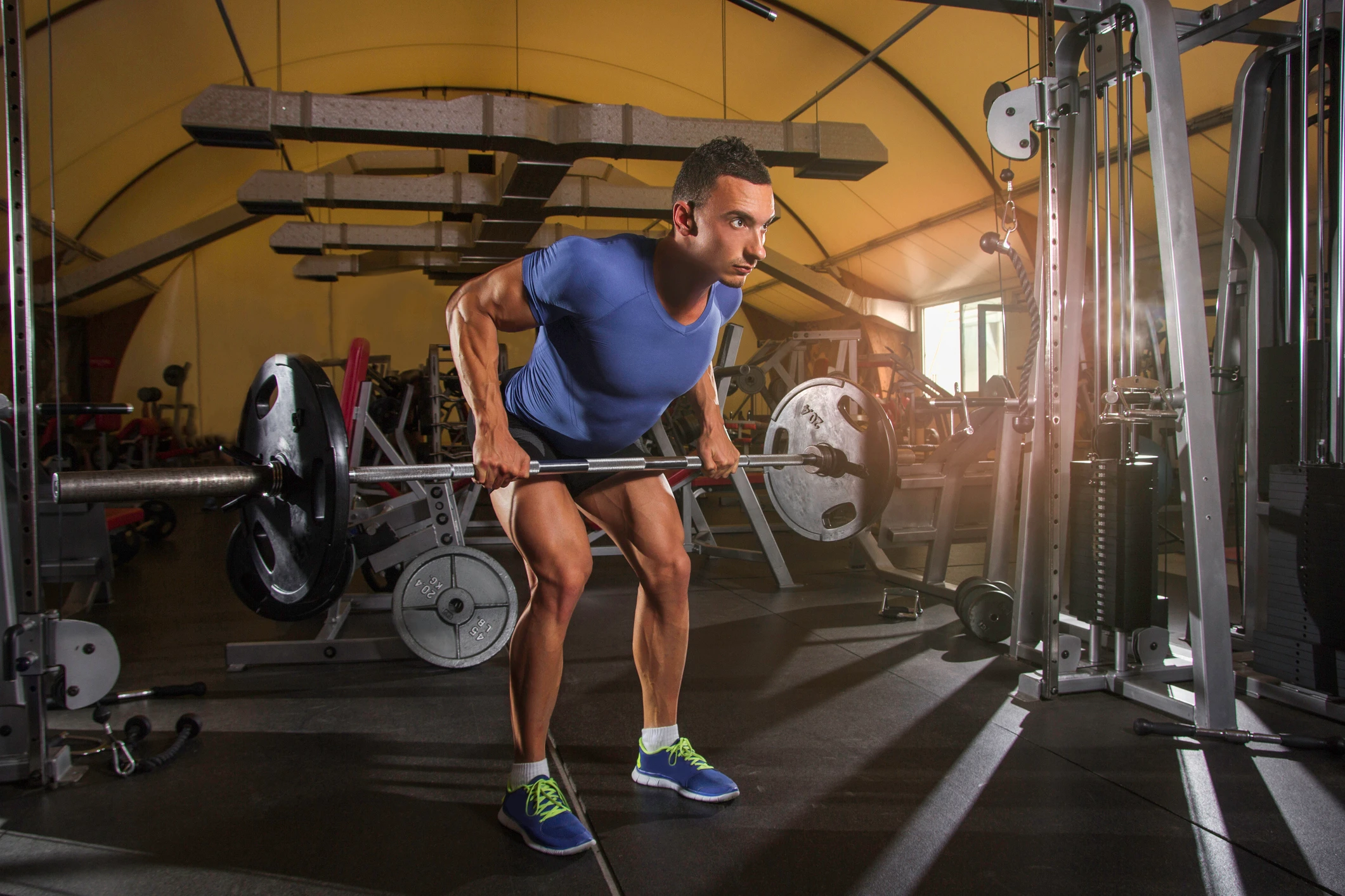 man doing barbell row in the gym as part of pull day
